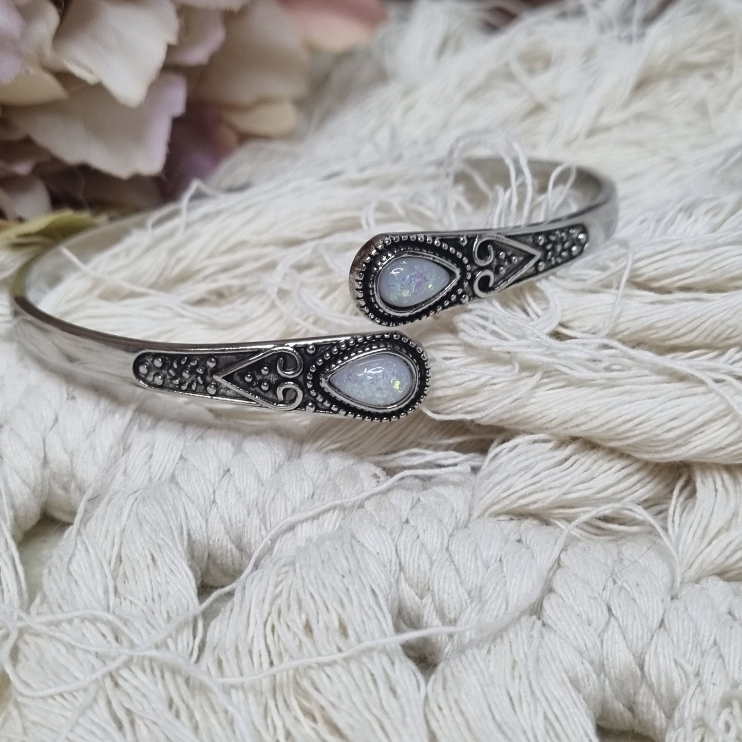Adjustable silver cuff bracelet with two teardrop opal stones and vintage detailing