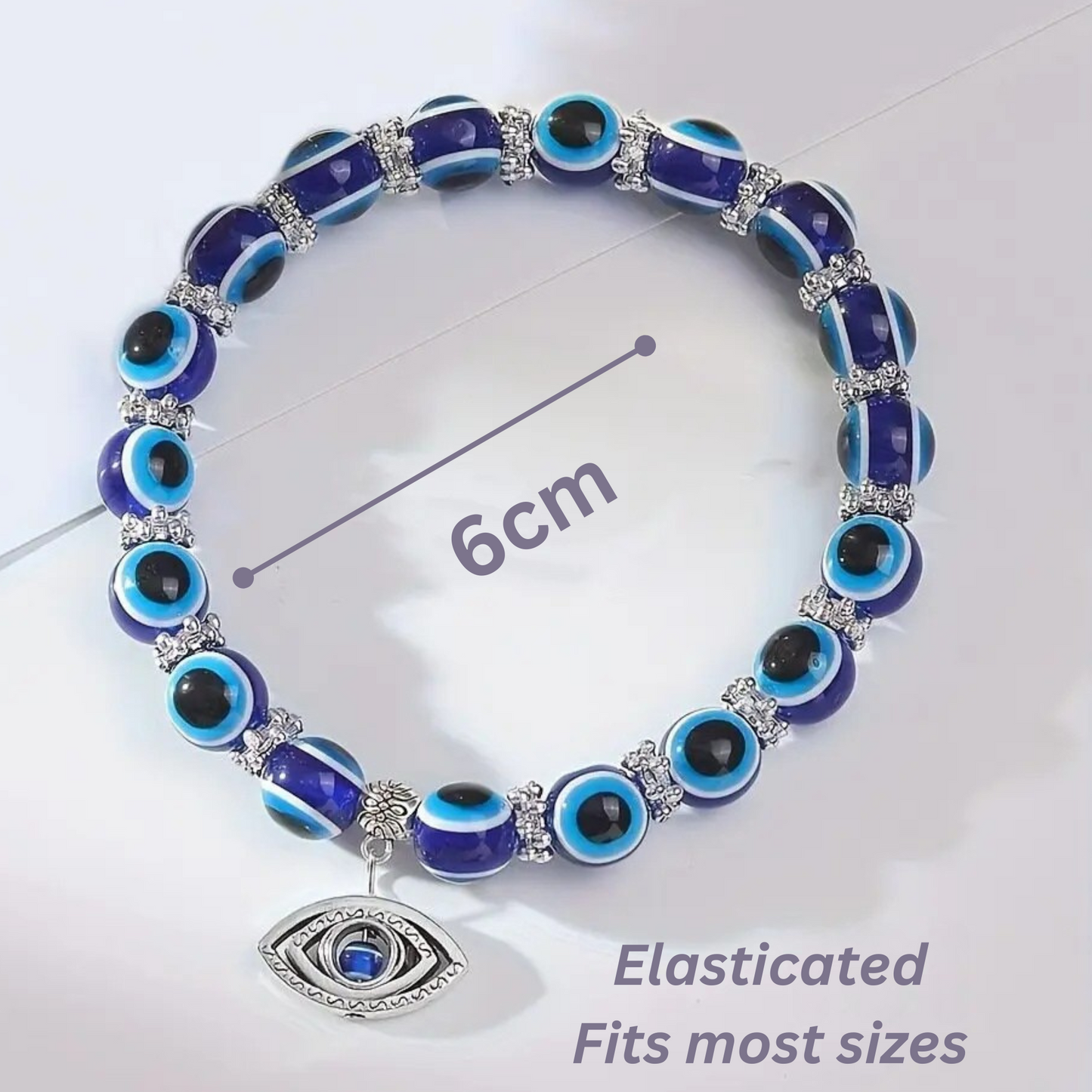 Blue and black beaded bracelet with an evil eye charm on a white background