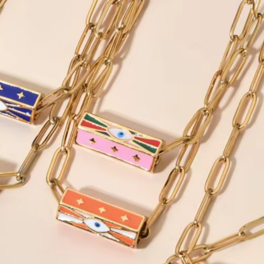 Enhance your style with our Resin Barrel Evil Eye Necklaces—a vibrant fusion of color, meaning, and playful charm. Featuring colorful resin barrel beads and a central Evil Eye design, this necklace isn’t just bold in style—it’s also a symbol of protection and positivity, traditionally believed to ward off negative energy and attract good fortune.