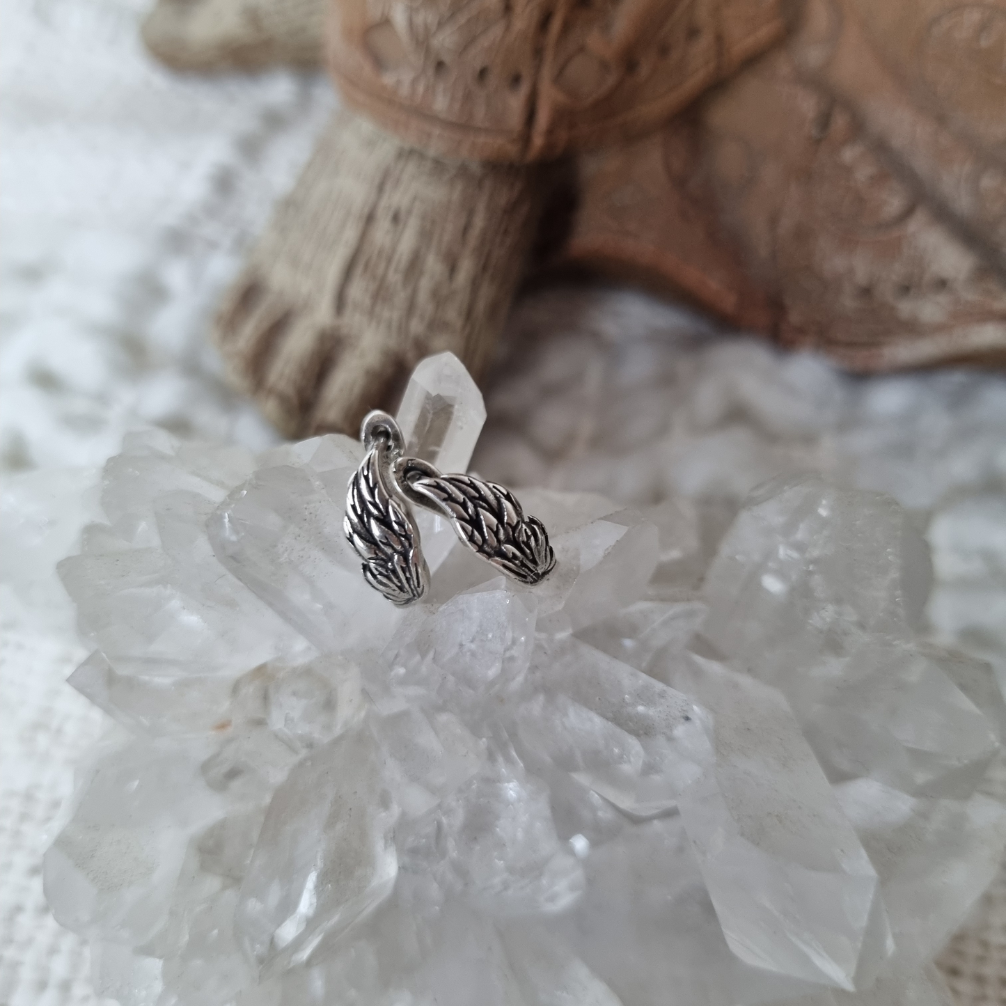 Silver earrings on a crystal