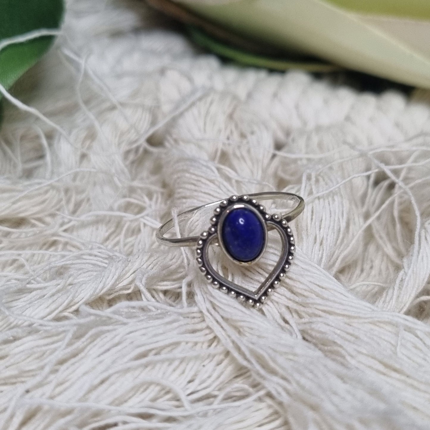 Sterling silver lapis lazuli ring photographed on neutral background