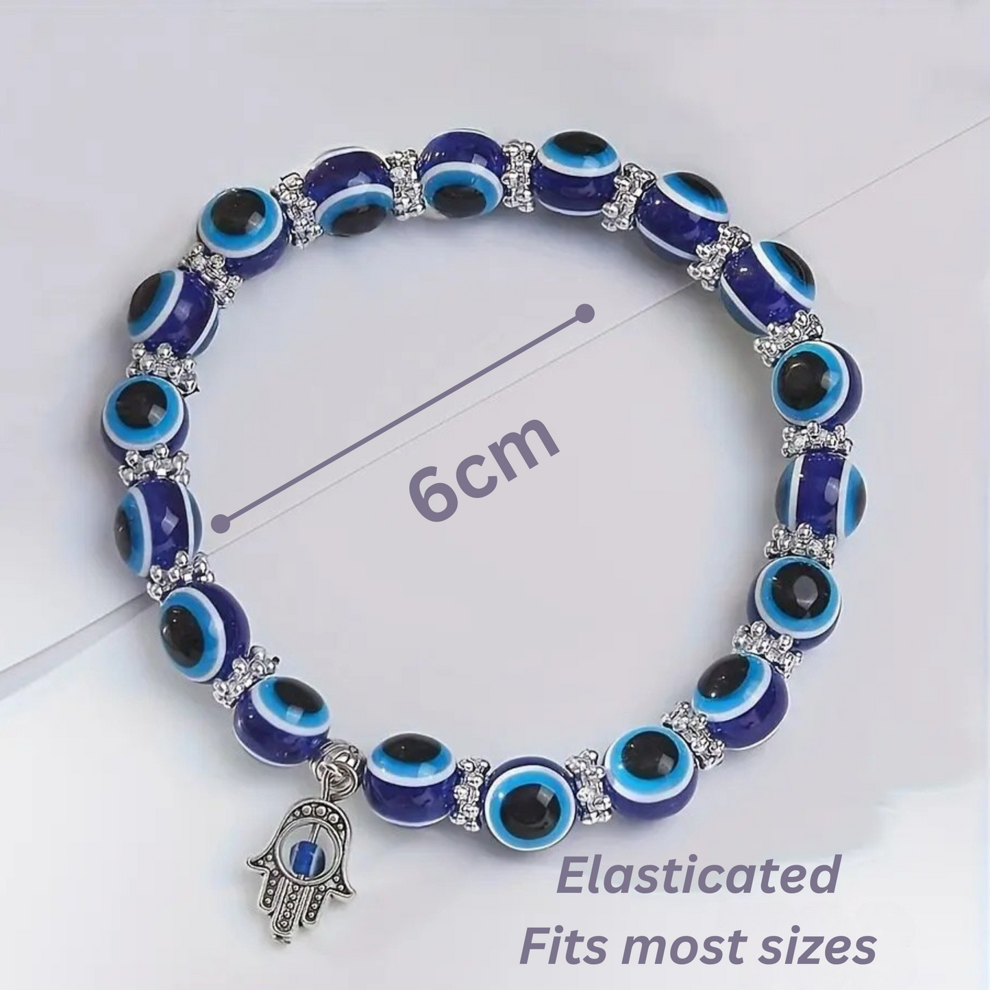 Bracelet with blue and black eye-shaped beads and a Hamsa charm on a white background.
