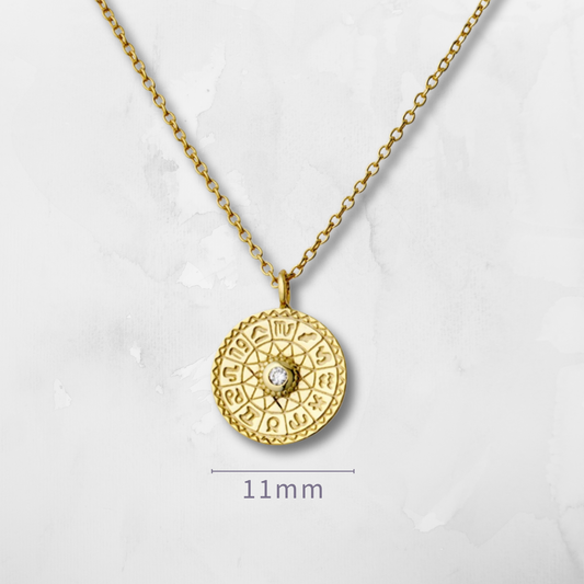 Zodiac Wheel Necklace, a celestial statement piece that captures the mystery and beauty of the universe. Featuring a finely detailed circular zodiac charm