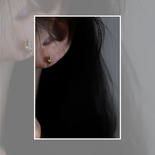 Green Zircon Stud Earrings, available in both 925 sterling silver and 18K gold-plated sterling silver. These dainty, hypoallergenic studs are perfect for everyday wear, adding a gentle sparkle and touch of color to any ear stack.