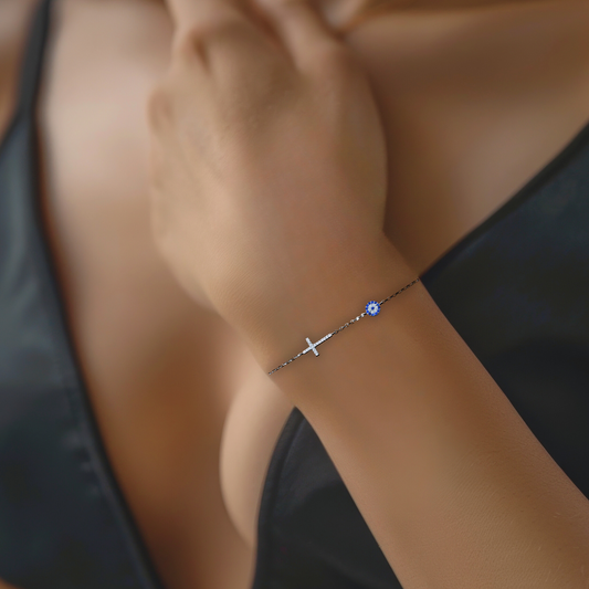 Silver Evil Eye & Cross Bracelet combines two powerful spiritual symbols in one delicate piece.