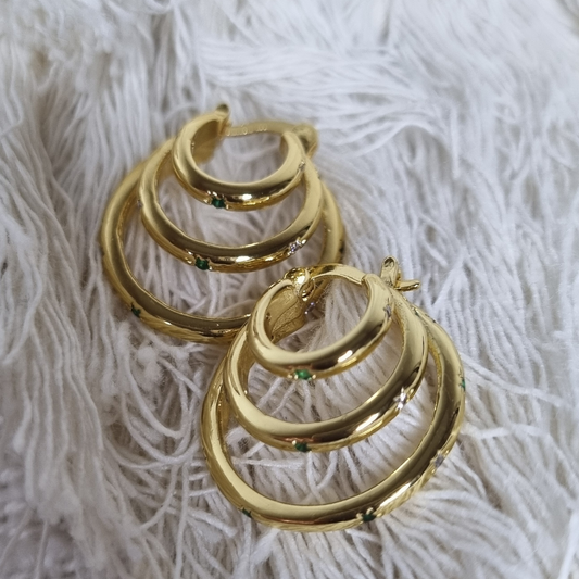 Side view of gold-plated sterling silver hoop earrings, showing layered hoop design with emerald-colored and CZ stones.