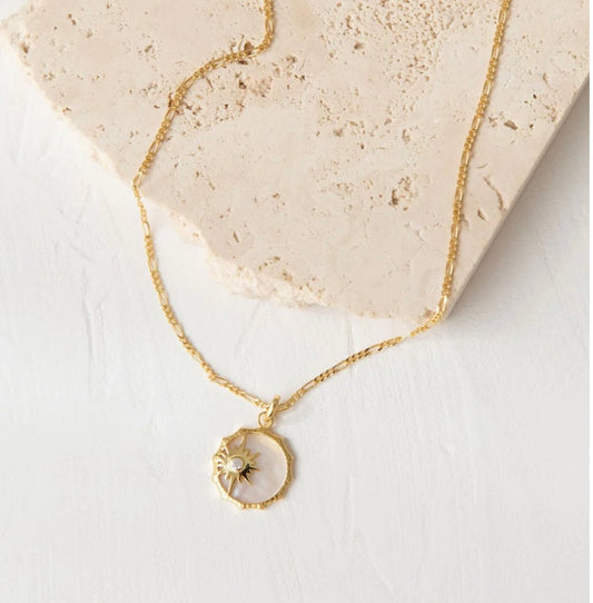 .925 sterling silver and plated in 18K gold, the pendant is suspended from a figaro chain
