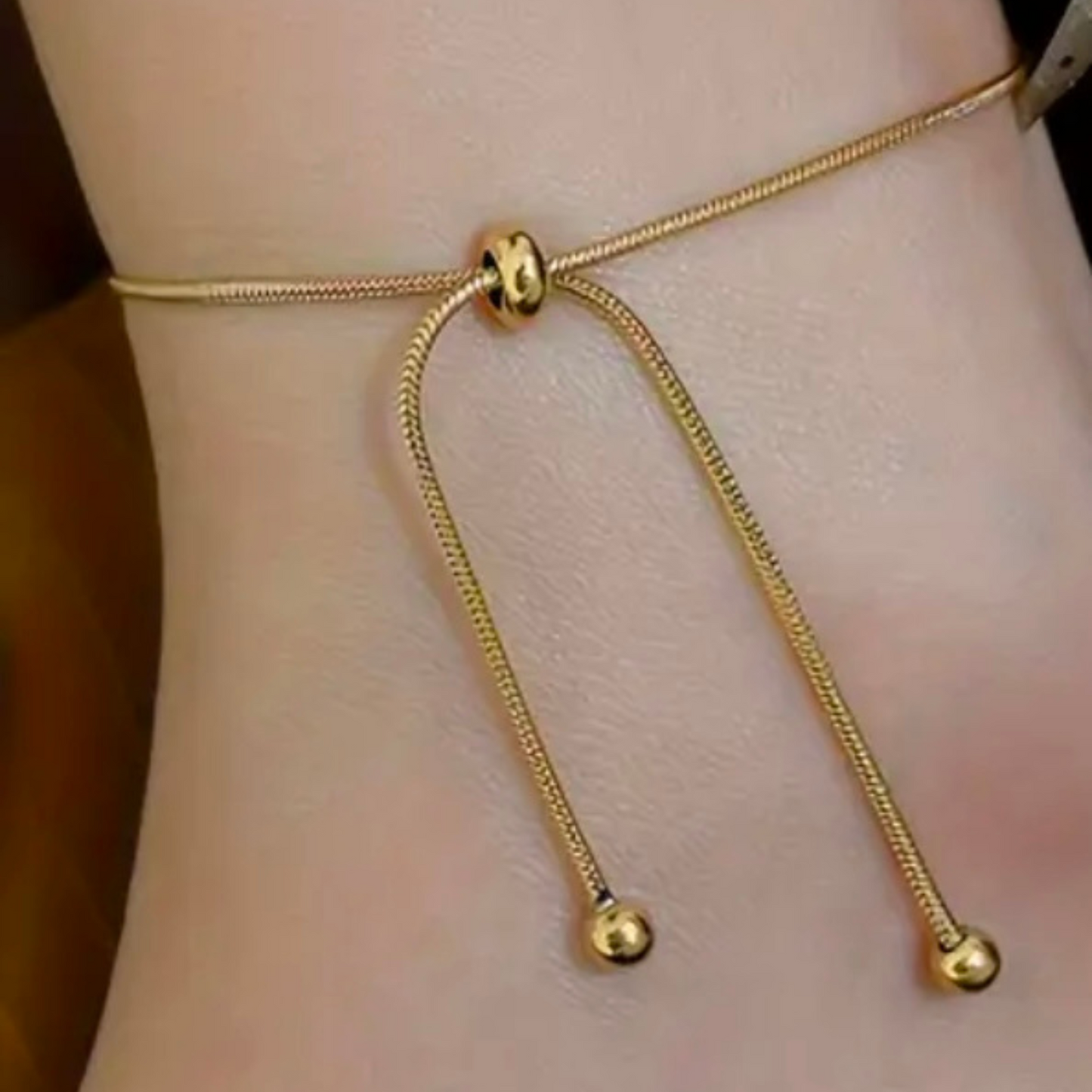 One chain, two ways to shine. This Adjustable Telescopic Chain in radiant 18K gold plating is designed for effortless versatility—wear it as a delicate bracelet or as a sleek anklet, depending on your mood and style.