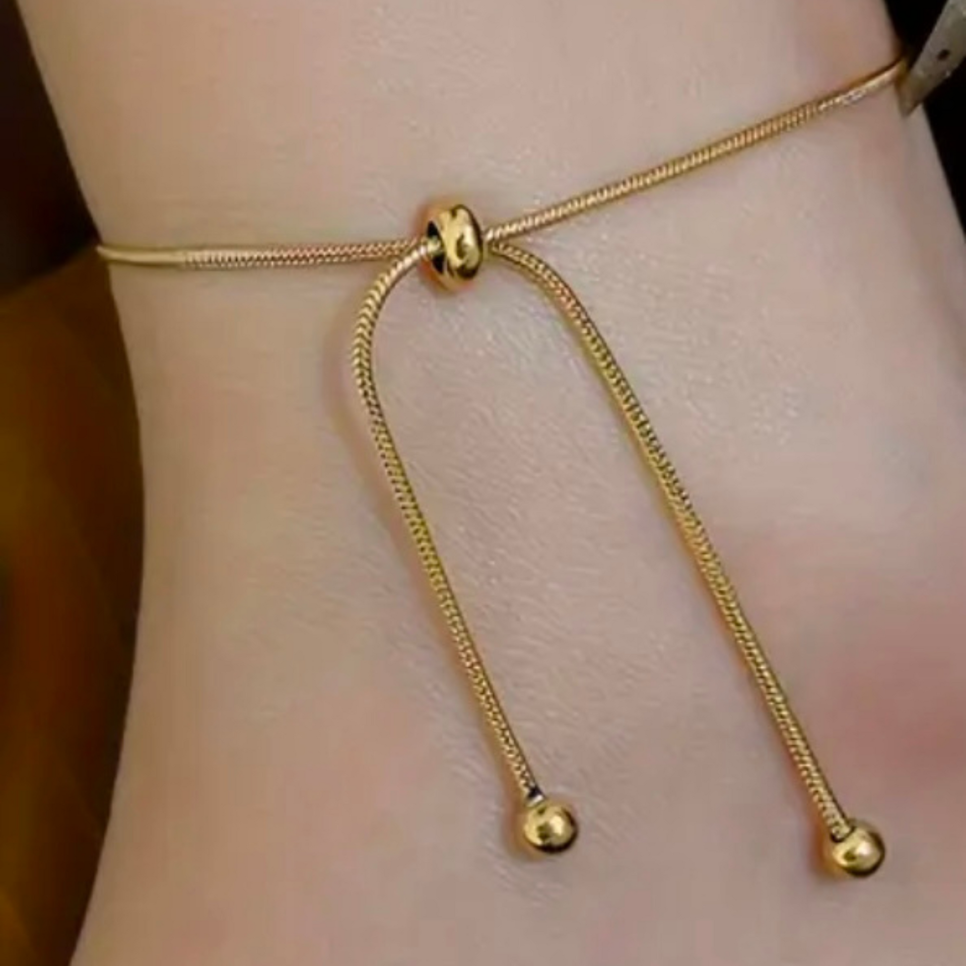 One chain, two ways to shine. This Adjustable Telescopic Chain in radiant 18K gold plating is designed for effortless versatility—wear it as a delicate bracelet or as a sleek anklet, depending on your mood and style.