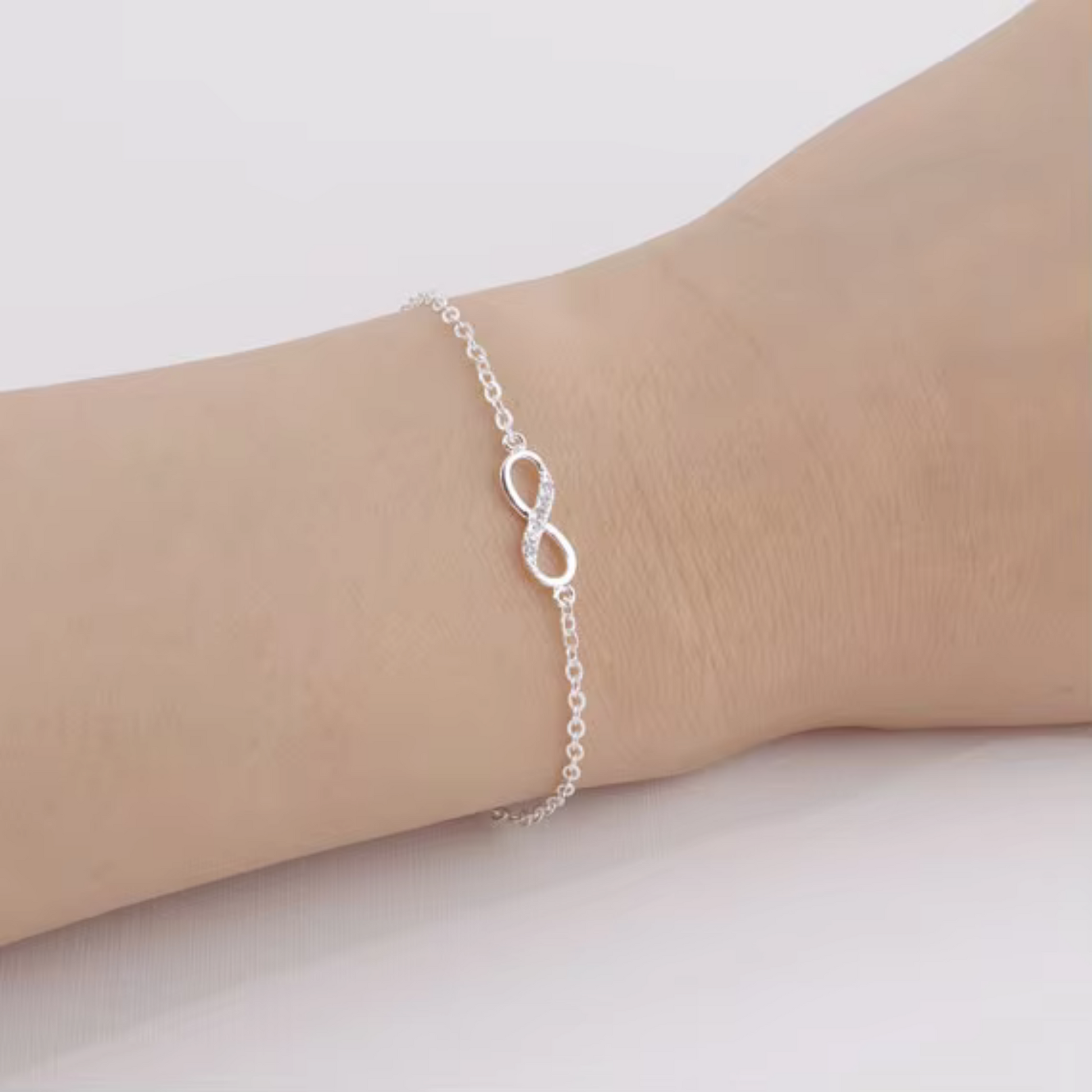 Infinity Bracelet, a delicate yet meaningful piece designed to shine with purpose. Crafted from .925 sterling silver and accented with cubic zirconia for a soft