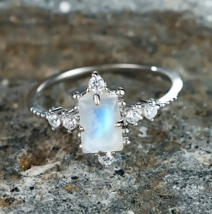 Embrace new beginnings with our stunning Silver Moonstone Ring, designed to symbolize light, clarity, and feminine strength. At its center is a luminous moonstone gemstone, surrounded by sparkling cubic zirconia that enhances its ethereal beauty.