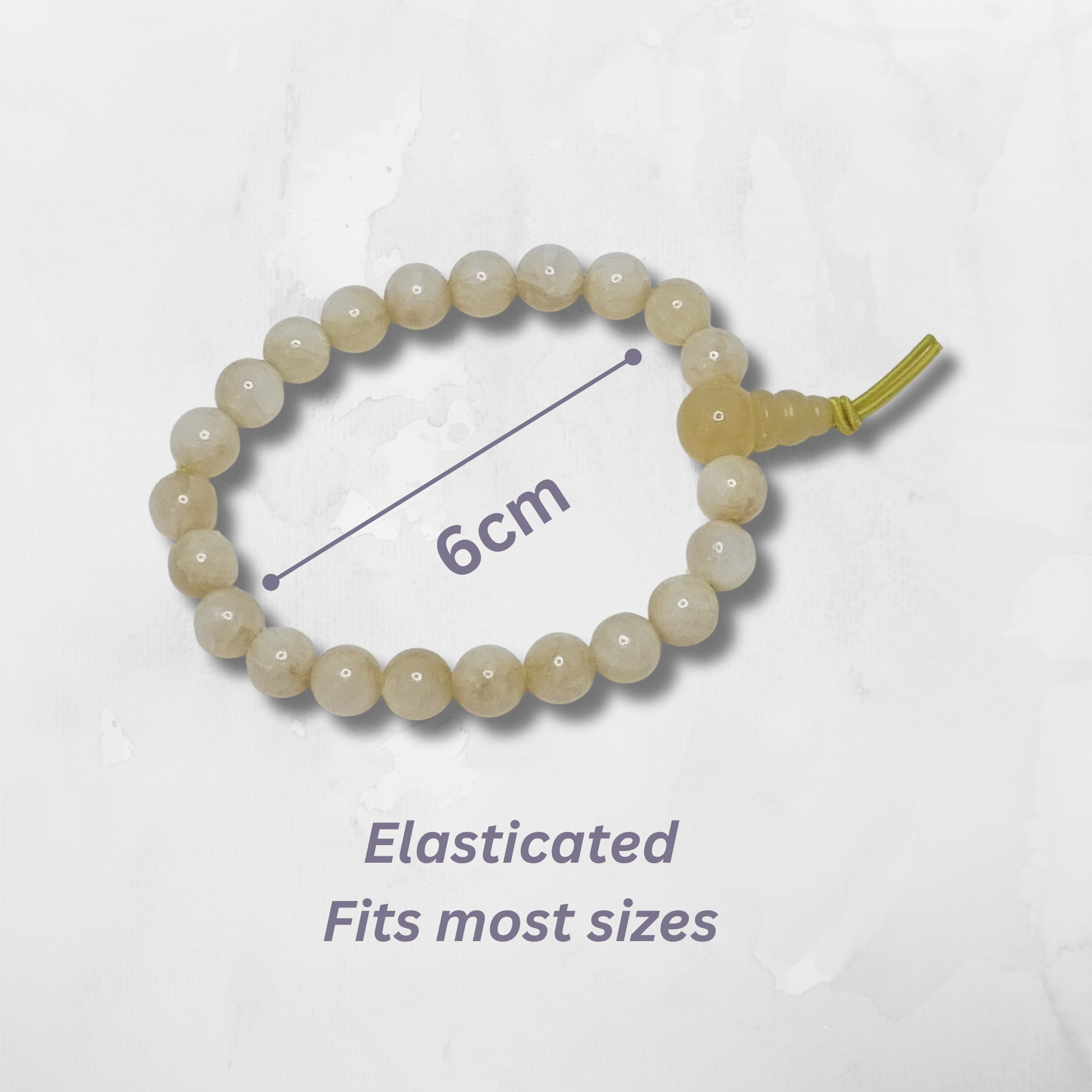 Beaded bracelet with an elasticated band on a light gray background with measurement indication. Yellow Calcite Tumblestone
