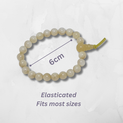 Beaded bracelet with an elasticated band on a light gray background with measurement indication. Yellow Calcite Tumblestone